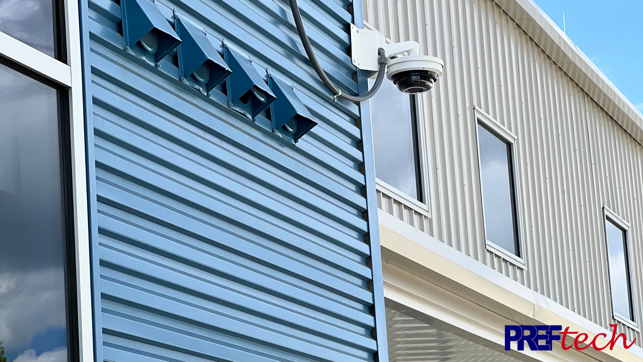 A white enterprise camera on the side of a building or school.